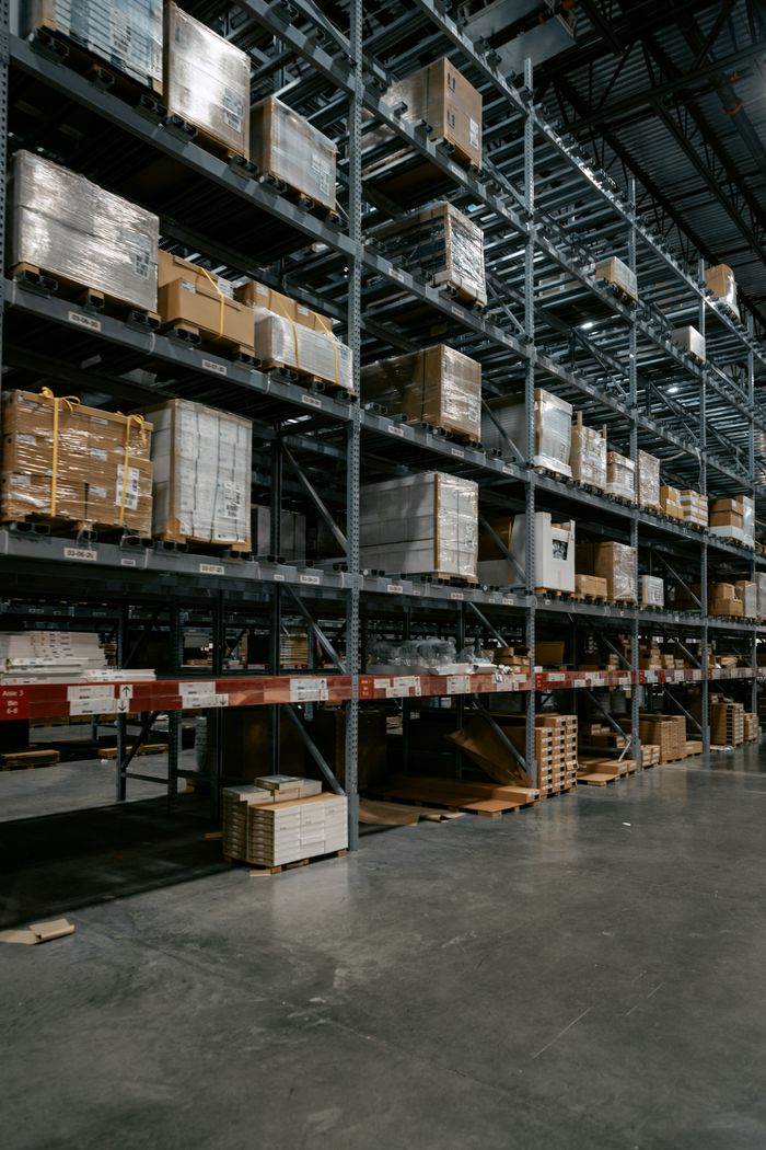 project-03-b A well-organized industrial warehouse with stacked shelves and various pallets for efficient storage.