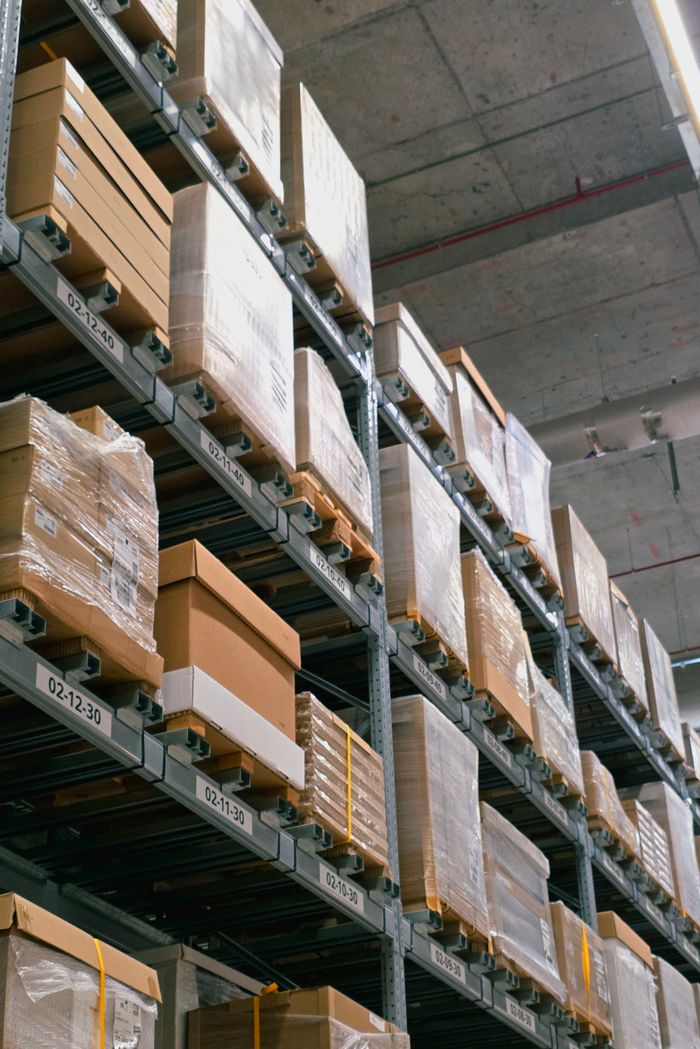 project-02-d A warehouse showcasing organized shelves with stacked cardboard boxes for storage and logistics.